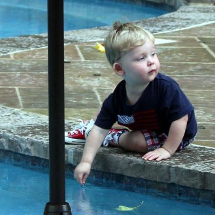 toddler at pool edge
