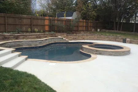 Replacement Pool Spa Project with raised spa and stone-faced water-feature wall