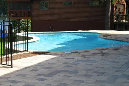 Lake of the Woods curved pool beside the home and paved patio