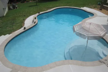 Raised and Reverse Bond Beams pool with a curved shape and shallow shelf