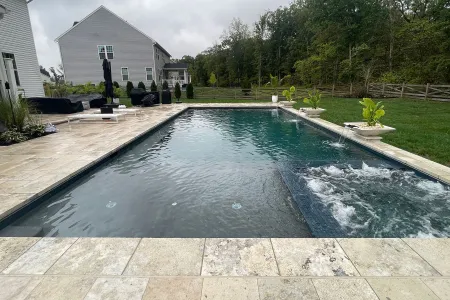 Rectangular Miller-Haymarket pool with patio and water features