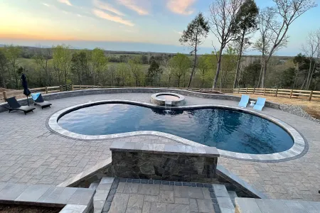 Olsen-Locust Grove kidney-shaped pool, raised spa and surrounding patio