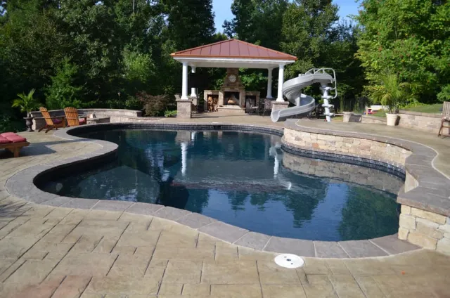 Freeform pool with raised spa, pavilion and surrounding patio
