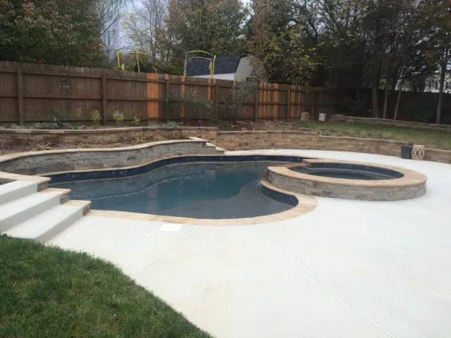 Replacement Pool Spa Project with raised spa and stone-faced water-feature wall