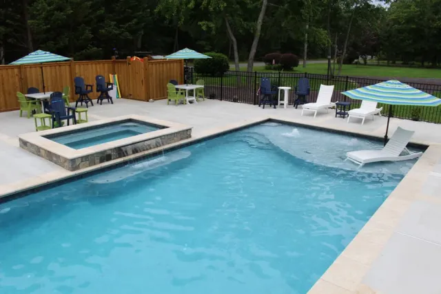 Colonial Beach raised spa spilling into the rectangular pool