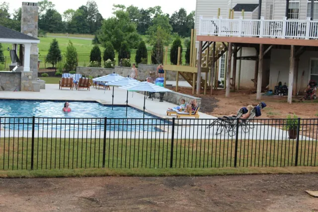 Backyard Resort rectangular pool with umbrellas, patio and outdoor pavilion