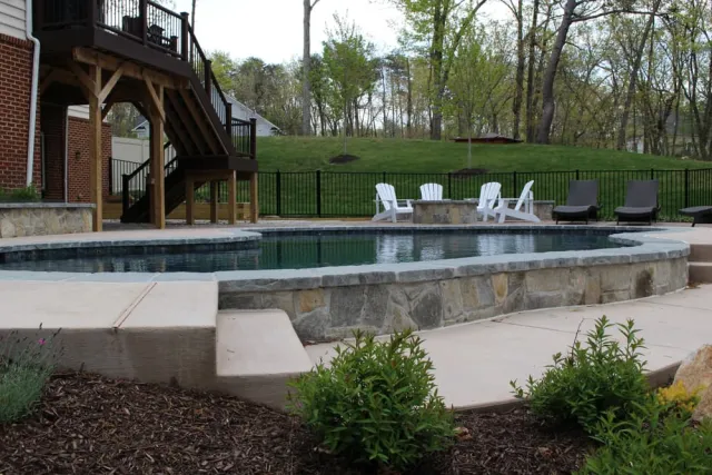Stone-faced River Bend pool wall and steps between patio levels