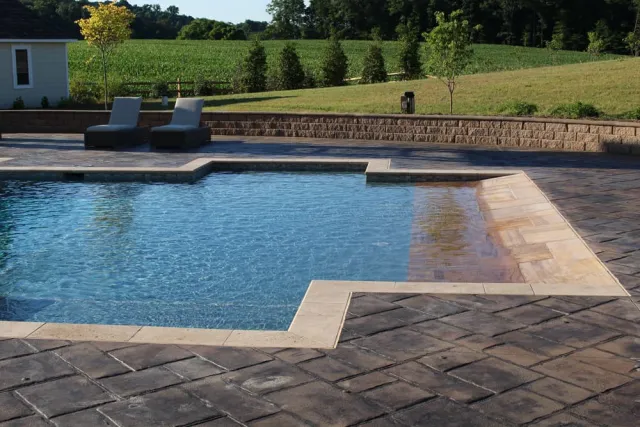 Travertine coping along the Unionville portfolio pool's geometric edge