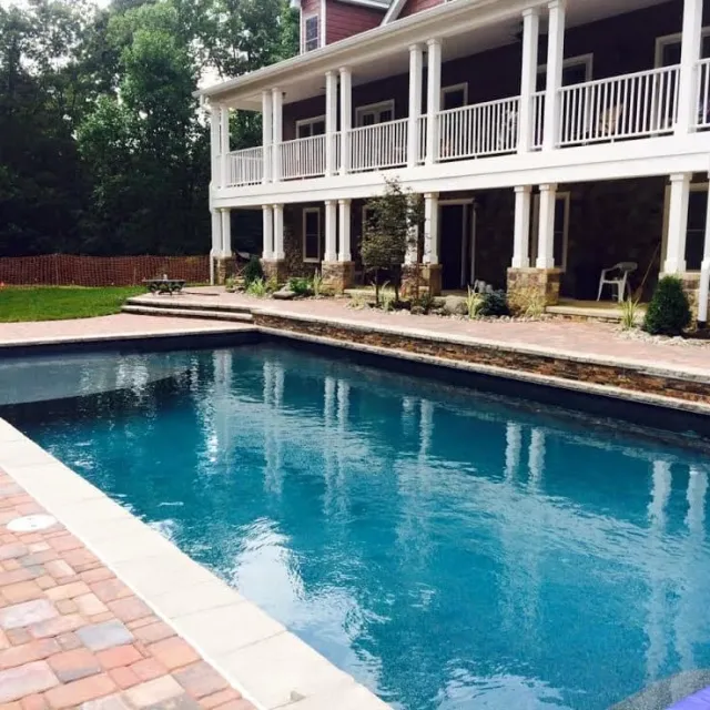 Pine Knoll pool with shallow shelf and water features along the raised wall