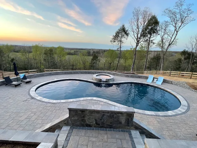 Olsen-Locust Grove kidney-shaped pool, raised spa and surrounding patio