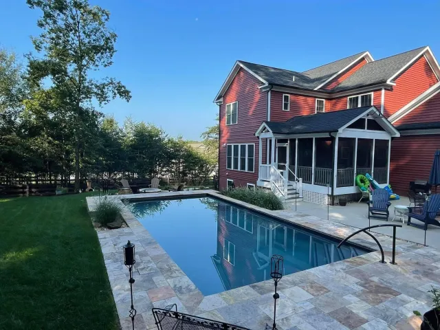 Johnson-Stafford straight-sided pool beside the home and surrounding stone patio